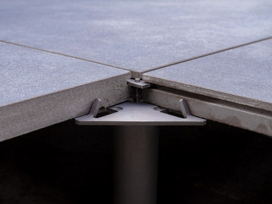 Integrates into specialist pedestals to secure porcelain tiles against the effects of wind uplift